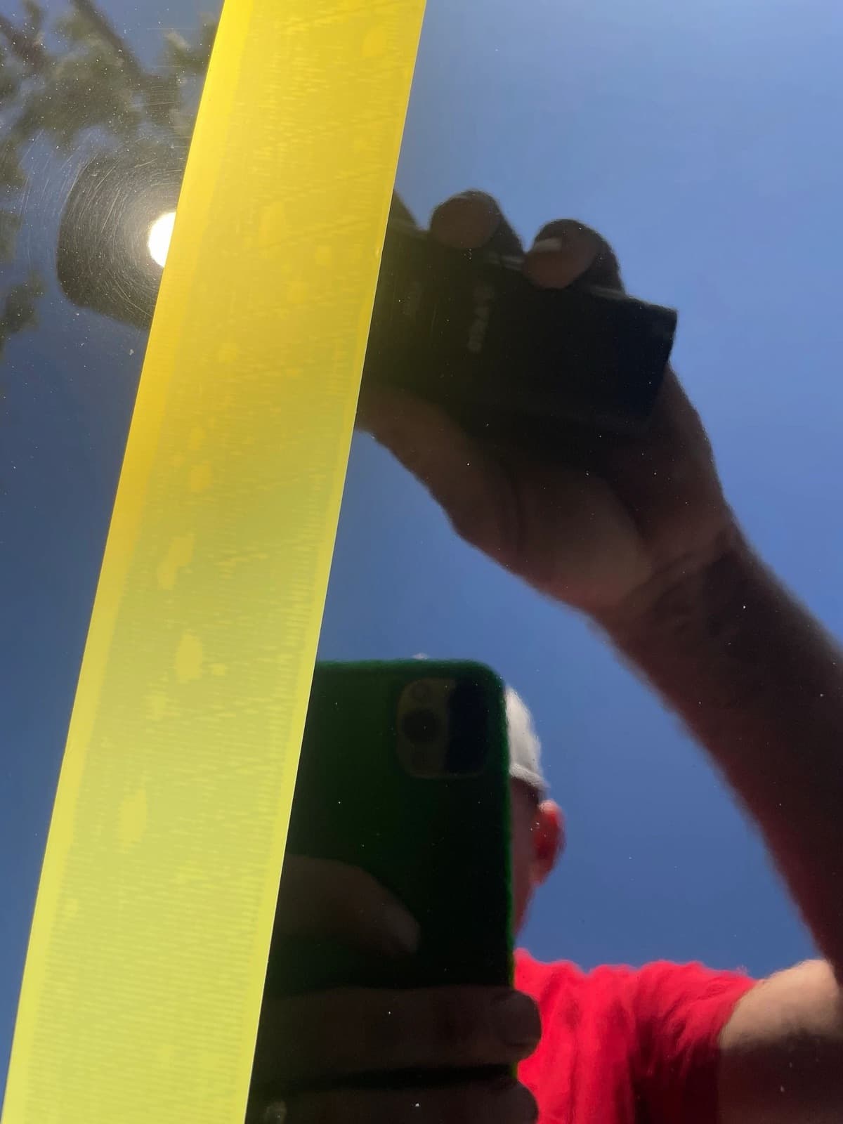 Polishing pad held up against the sky during a detail